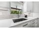 Kitchen sink with modern faucet and window with a view of the outdoor pool at 1404 84Th N Ave, St Petersburg, FL 33702
