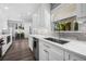 A modern kitchen featuring white cabinetry, stainless steel appliances, and a view of the outdoor pool at 1404 84Th N Ave, St Petersburg, FL 33702