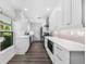 Bright modern kitchen with white cabinets, hardwood floors, and ample counter space at 1404 84Th N Ave, St Petersburg, FL 33702