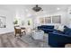 Comfortable living area featuring a blue sofa, chic coffee table, and plenty of natural light at 1404 84Th N Ave, St Petersburg, FL 33702