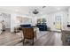 A spacious living room with a blue sofa, stylish lighting, and light wood-look floors at 1404 84Th N Ave, St Petersburg, FL 33702