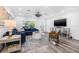 An open living room with blue sectional sofa, modern decor, and ample natural light at 1404 84Th N Ave, St Petersburg, FL 33702