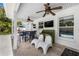 Covered outdoor patio area with ceiling fans, dining set, and a view of the pool at 1404 84Th N Ave, St Petersburg, FL 33702