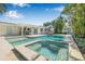 The backyard showcases a beautiful pool, spa, lush landscaping, and a covered patio for relaxing and entertaining at 1404 84Th N Ave, St Petersburg, FL 33702