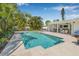 An inground pool with an outdoor kitchen and covered patio makes for an entertainer's dream at 1404 84Th N Ave, St Petersburg, FL 33702