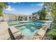 The backyard boasts a gorgeous pool, spa, outdoor seating, and a covered patio perfect for entertaining at 1404 84Th N Ave, St Petersburg, FL 33702