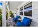 Inviting front porch with stylish blue cushioned chairs and a charming seating area at 1404 84Th N Ave, St Petersburg, FL 33702