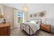 Bedroom showcasing a bed, chandelier and a water view at 16419 Sapphire Point Dr, Lakewood Ranch, FL 34211