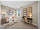 Comfortable bedroom with a modern sofa, desk, and a large clock at 16419 Sapphire Point Dr, Lakewood Ranch, FL 34211