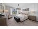 Primary bedroom with neutral decor, accent wall, and view of the outdoors at 16419 Sapphire Point Dr, Lakewood Ranch, FL 34211