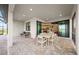 Spacious covered patio has a dining table with six chairs and a view into the home's kitchen and living area at 16419 Sapphire Point Dr, Lakewood Ranch, FL 34211