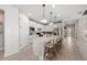 Modern kitchen featuring white cabinetry, stainless steel appliances, and a large center island with seating at 16419 Sapphire Point Dr, Lakewood Ranch, FL 34211