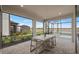 Enclosed lanai features a dining table with seating and views of the pool and a lake at 16419 Sapphire Point Dr, Lakewood Ranch, FL 34211