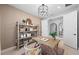 Office features a wooden desk, shelves, and a view into another room at 16419 Sapphire Point Dr, Lakewood Ranch, FL 34211