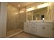 Modern bathroom featuring a glass shower, tile surround, double vanity, and contemporary fixtures at 1643 Springwell Ln, Sarasota, FL 34240
