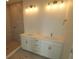 Modern bathroom featuring double sinks, updated fixtures, and a beautifully tiled shower stall at 1643 Springwell Ln, Sarasota, FL 34240