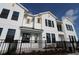 Modern townhome with white siding, black framed windows, yellow accents, and well-maintained landscaping at 1643 Springwell Ln, Sarasota, FL 34240