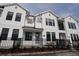 Beautiful townhome showcases a white exterior, black trim, and a decorative black fence at 1643 Springwell Ln, Sarasota, FL 34240