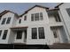 New two-story townhome featuring black-framed windows and white siding at 1643 Springwell Ln, Sarasota, FL 34240