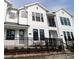 Charming white townhome featuring black trim and a small, landscaped front yard with fence at 1643 Springwell Ln, Sarasota, FL 34240