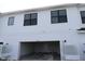 Townhome featuring a spacious garage with an attached two-story exterior at 1643 Springwell Ln, Sarasota, FL 34240