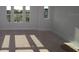 Living room featuring bright windows with views of houses and an unfinished floor at 1643 Springwell Ln, Sarasota, FL 34240