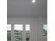 Bright living room with large windows offering a neighborhood view and recessed lighting at 1643 Springwell Ln, Sarasota, FL 34240