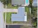 Aerial view of the house, showing the layout, landscaping, and proximity to the canal at 1812 Teakwood Ln, Dunedin, FL 34698