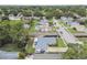 An aerial view of a single-story house and the surrounding landscape at 1812 Teakwood Ln, Dunedin, FL 34698