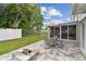 Backyard oasis with patio, fire pit, seating area, and lush green lawn at 1812 Teakwood Ln, Dunedin, FL 34698