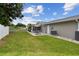 Large backyard with patio seating area, green lawn, and well-maintained landscaping at 1812 Teakwood Ln, Dunedin, FL 34698