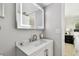 Bathroom includes modern lighting, sink, and entry to bedroom area at 1812 Teakwood Ln, Dunedin, FL 34698