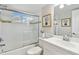 Bathroom features shower with glass doors, modern sink, and tile accents at 1812 Teakwood Ln, Dunedin, FL 34698