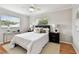 Bedroom featuring two windows, ceiling fan, and modern furniture with a bed at 1812 Teakwood Ln, Dunedin, FL 34698