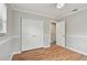 Bedroom featuring hardwood floors, fresh paint, a large closet, and an adjoining door at 1812 Teakwood Ln, Dunedin, FL 34698