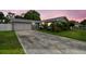 Charming single-story home with a well-maintained front yard and attached two-car garage at 1812 Teakwood Ln, Dunedin, FL 34698
