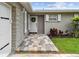 Close-up of the home's entrance, showcasing a decorative wreath and charming brick pathway at 1812 Teakwood Ln, Dunedin, FL 34698
