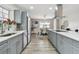 Bright kitchen featuring gray cabinets, stainless steel appliances, and modern countertops at 1812 Teakwood Ln, Dunedin, FL 34698