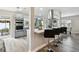 Bright kitchen with a large island, black bar stools, and modern appliances, perfect for entertaining at 1812 Teakwood Ln, Dunedin, FL 34698