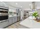 Well-appointed kitchen with sleek appliances, a mosaic backsplash, and plenty of counter space at 1812 Teakwood Ln, Dunedin, FL 34698
