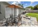 Cozy patio with seating, outdoor dining, and a fire pit, perfect for outdoor entertaining at 1812 Teakwood Ln, Dunedin, FL 34698