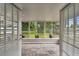 Bright and airy sunroom showcasing tiled floors and large windows with backyard views at 1812 Teakwood Ln, Dunedin, FL 34698