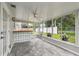 Spacious sunroom with bar area, tiled floors, backyard views, and access to outdoor living spaces at 1812 Teakwood Ln, Dunedin, FL 34698