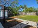 Spacious backyard with stone pathway, a shed, and lush landscaping, creating a relaxing outdoor space at 1818 Douglas Ave, Dunedin, FL 34698