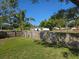 Fenced backyard with a lush green lawn, providing privacy and space for outdoor activities at 1818 Douglas Ave, Dunedin, FL 34698