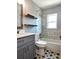 Stylish bathroom with tiled shower, modern vanity, and decorative shelving at 1818 Douglas Ave, Dunedin, FL 34698