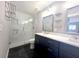 Stylish bathroom featuring a double vanity, tiled floors, and a glass-enclosed shower at 1818 Douglas Ave, Dunedin, FL 34698