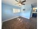 Sunny bedroom featuring pale blue walls, tiled floors, and large windows with plantation shutters at 1818 Douglas Ave, Dunedin, FL 34698
