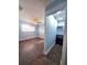Bedroom with en suite access to a walk-in closet featuring blue walls, tiled floors, and plantation shutters at 1818 Douglas Ave, Dunedin, FL 34698
