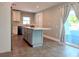 A modern kitchen featuring a stylish island with sleek countertops and gray cabinets at 1818 Douglas Ave, Dunedin, FL 34698